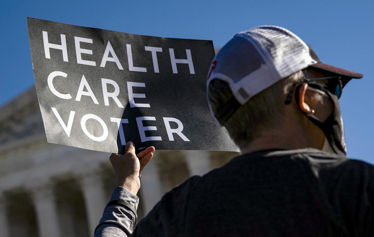 Health care voter holding up a sign